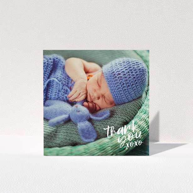 A baby card design titled "Thanks In the Corner". It is a square (148mm x 148mm) card in a square orientation. It is a photographic baby card with room for 1 photo. "Thanks In the Corner" is available as a folded card, with mainly white colouring.