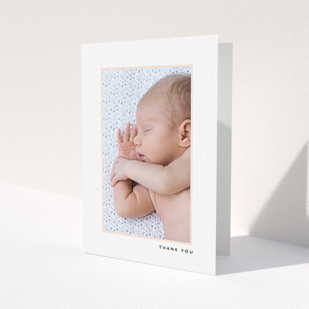 A baby card design called 'Thin Pink Frame'. It is an A6 card in a portrait orientation. It is a photographic baby card with room for 1 photo. 'Thin Pink Frame' is available as a folded card, with tones of white and pink.