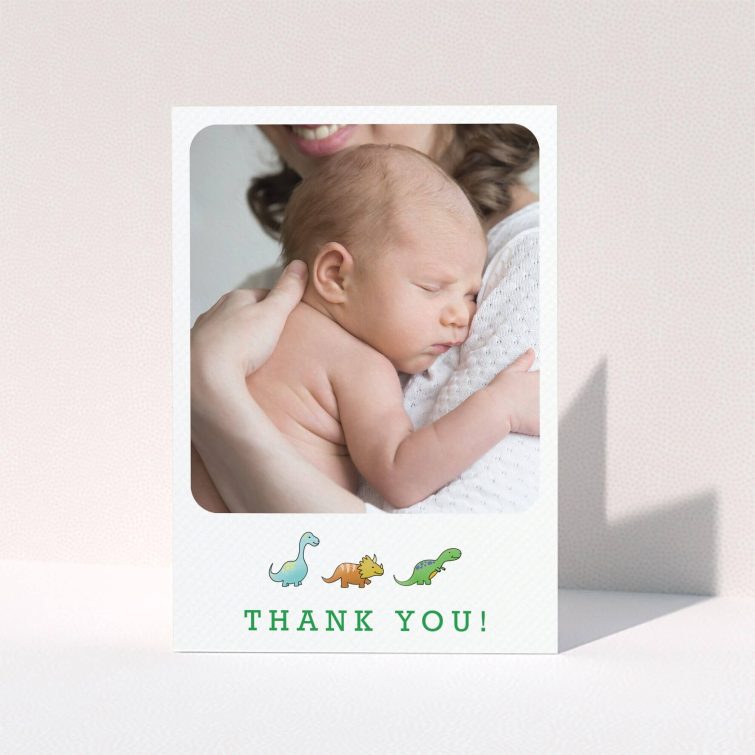 A baby thank you card design called "BabySaurus". It is an A6 card in a portrait orientation. It is a photographic baby thank you card with room for 1 photo. "BabySaurus" is available as a folded card, with tones of white, green and light blue.