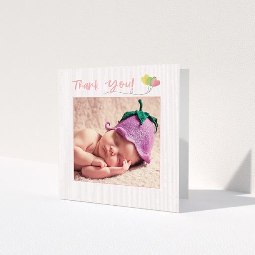 A baby thank you card design called 'Balloooons'. It is a square (148mm x 148mm) card in a square orientation. It is a photographic baby thank you card with room for 1 photo. 'Balloooons' is available as a folded card, with mainly pink colouring.