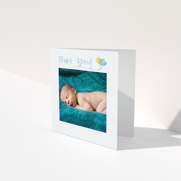 A baby thank you card design named "Balloooons". It is a square (148mm x 148mm) card in a square orientation. It is a photographic baby thank you card with room for 1 photo. "Balloooons" is available as a folded card, with mainly blue colouring.