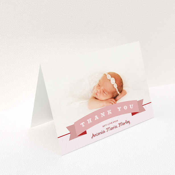 A baby thank you card called "Big Banner". It is an A5 card in a landscape orientation. It is a photographic baby thank you card with room for 1 photo. "Big Banner" is available as a folded card, with tones of pink and white.