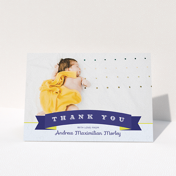 A baby thank you card design called "Big Banner". It is an A6 card in a landscape orientation. It is a photographic baby thank you card with room for 1 photo. "Big Banner" is available as a folded card, with tones of navy blue and white.