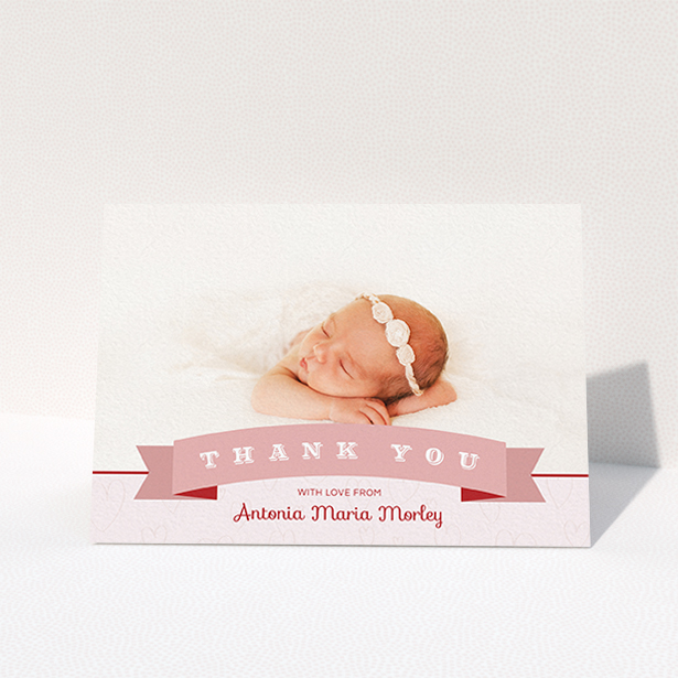 A baby thank you card design titled "Big Banner". It is an A6 card in a landscape orientation. It is a photographic baby thank you card with room for 1 photo. "Big Banner" is available as a folded card, with tones of pink and white.