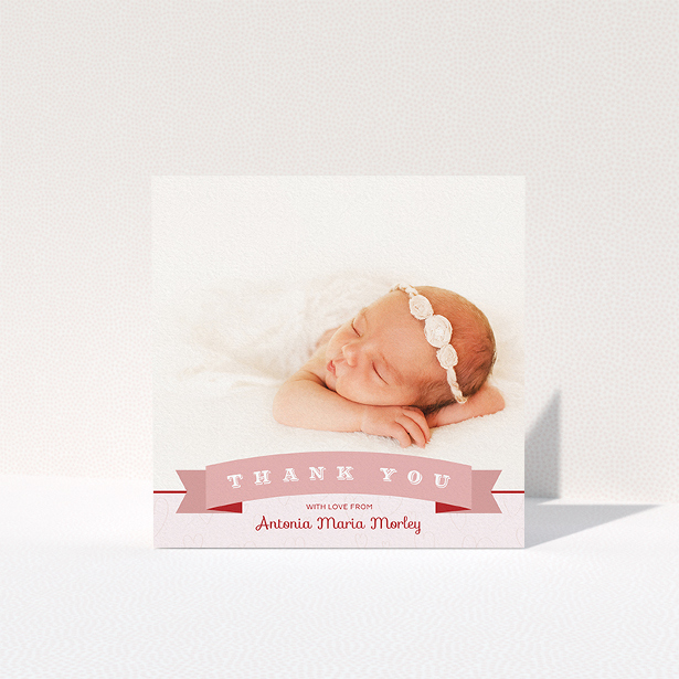 A baby thank you card named "Big Banner". It is a square (148mm x 148mm) card in a square orientation. It is a photographic baby thank you card with room for 1 photo. "Big Banner" is available as a folded card, with tones of pink and white.