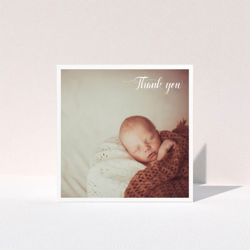 A baby thank you card design called "Central Square Frame". It is a square (148mm x 148mm) card in a square orientation. It is a photographic baby thank you card with room for 1 photo. "Central Square Frame" is available as a folded card, with mainly white colouring.