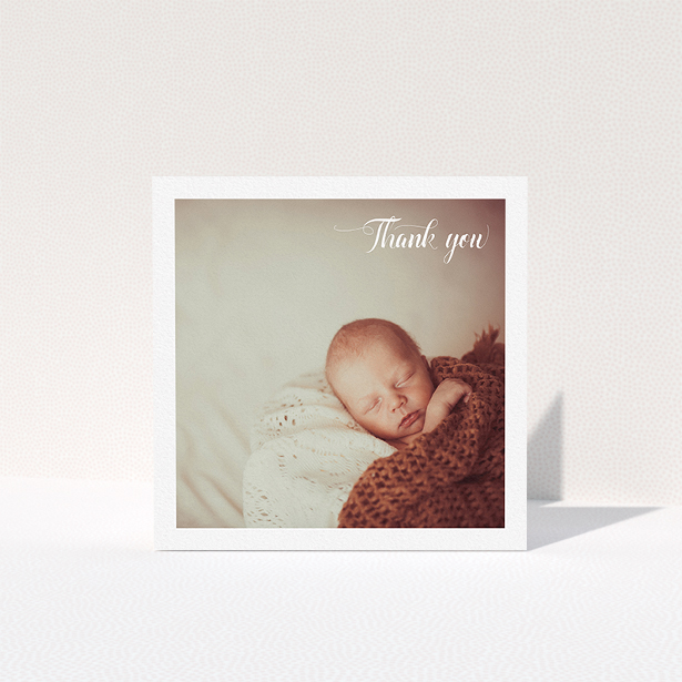 A baby thank you card design called "Central Square Frame". It is a square (148mm x 148mm) card in a square orientation. It is a photographic baby thank you card with room for 1 photo. "Central Square Frame" is available as a folded card, with mainly white colouring.