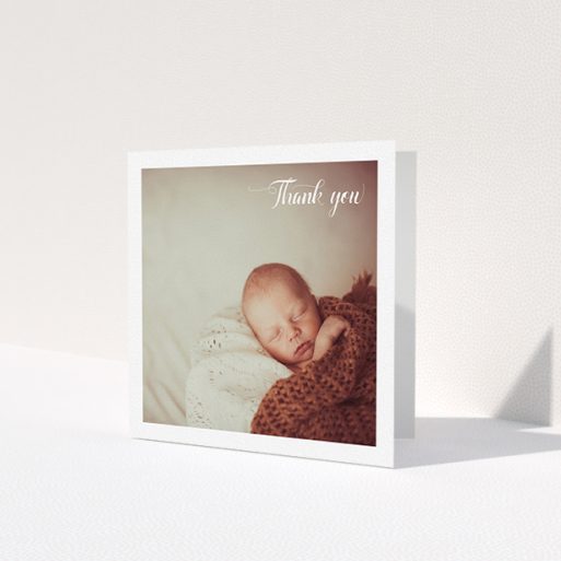 A baby thank you card design called 'Central Square Frame'. It is a square (148mm x 148mm) card in a square orientation. It is a photographic baby thank you card with room for 1 photo. 'Central Square Frame' is available as a folded card, with mainly white colouring.