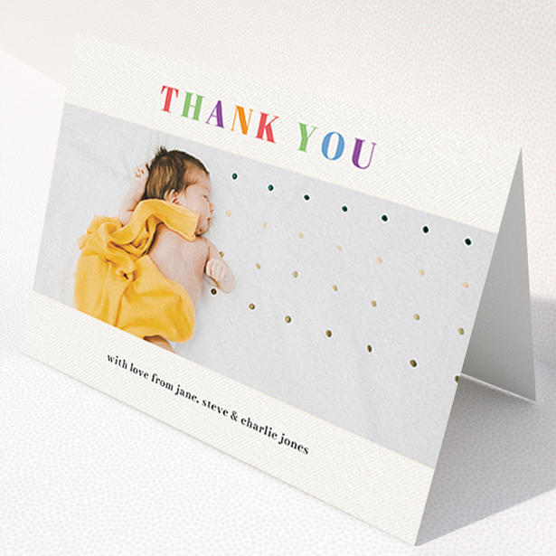 A baby thank you card named "Colourful Thanks". It is an A6 card in a landscape orientation. It is a photographic baby thank you card with room for 1 photo. "Colourful Thanks" is available as a folded card, with tones of white and green.