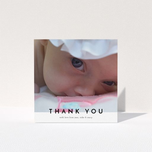A baby thank you card design titled "Cross Border". It is a square (148mm x 148mm) card in a square orientation. It is a photographic baby thank you card with room for 1 photo. "Cross Border" is available as a folded card, with mainly white colouring.