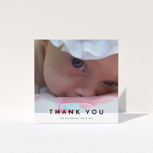 A baby thank you card design titled "Cross Border". It is a square (148mm x 148mm) card in a square orientation. It is a photographic baby thank you card with room for 1 photo. "Cross Border" is available as a folded card, with mainly white colouring.