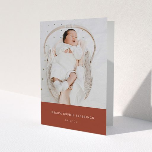 A baby thank you card called 'Dark Ochre Footer'. It is an A5 card in a portrait orientation. It is a photographic baby thank you card with room for 1 photo. 'Dark Ochre Footer' is available as a folded card, with mainly dark orange colouring.