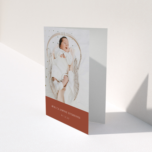 A baby thank you card called "Dark Ochre Footer". It is an A5 card in a portrait orientation. It is a photographic baby thank you card with room for 1 photo. "Dark Ochre Footer" is available as a folded card, with mainly dark orange colouring.