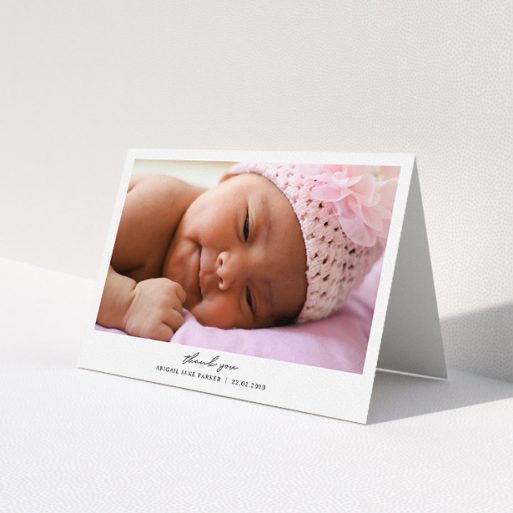A baby thank you card design named 'Everything You Need'. It is an A5 card in a landscape orientation. It is a photographic baby thank you card with room for 1 photo. 'Everything You Need' is available as a folded card, with mainly white colouring.