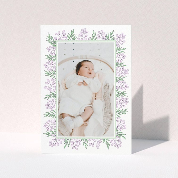 A baby thank you card named "Floral Frame". It is an A6 card in a portrait orientation. It is a photographic baby thank you card with room for 1 photo. "Floral Frame" is available as a folded card, with tones of purple and green.