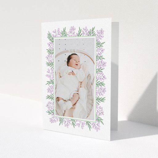 A baby thank you card named 'Floral Frame'. It is an A6 card in a portrait orientation. It is a photographic baby thank you card with room for 1 photo. 'Floral Frame' is available as a folded card, with tones of purple and green.