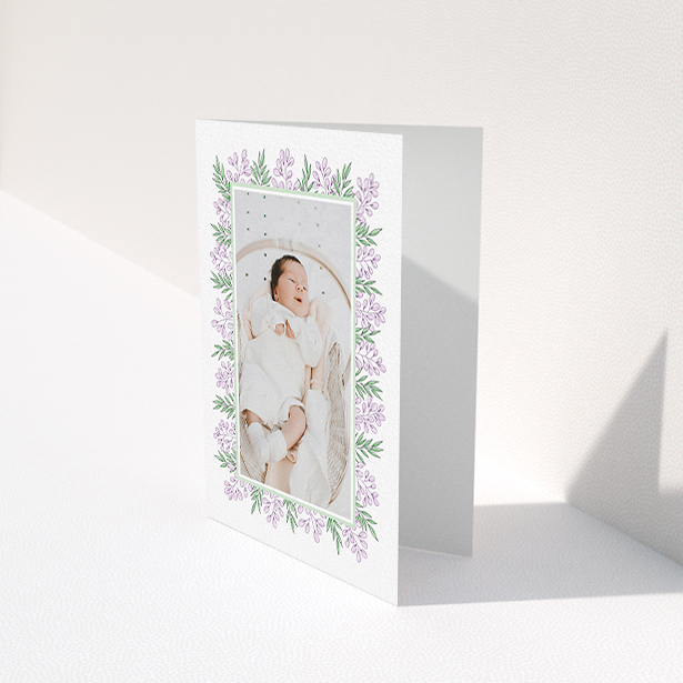 A baby thank you card named "Floral Frame". It is an A6 card in a portrait orientation. It is a photographic baby thank you card with room for 1 photo. "Floral Frame" is available as a folded card, with tones of purple and green.