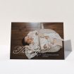 A baby thank you card called "Flourished Thank You". It is an A5 card in a landscape orientation. It is a photographic baby thank you card with room for 1 photo. "Flourished Thank You" is available as a folded card, with mainly white colouring.