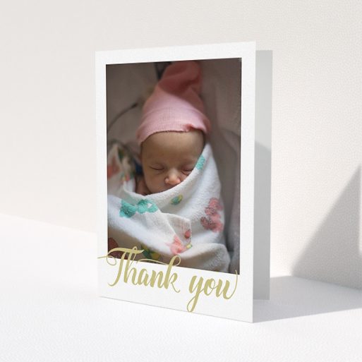 A baby thank you card design called 'Golden Thank You'. It is an A5 card in a portrait orientation. It is a photographic baby thank you card with room for 1 photo. 'Golden Thank You' is available as a folded card, with tones of white and gold.