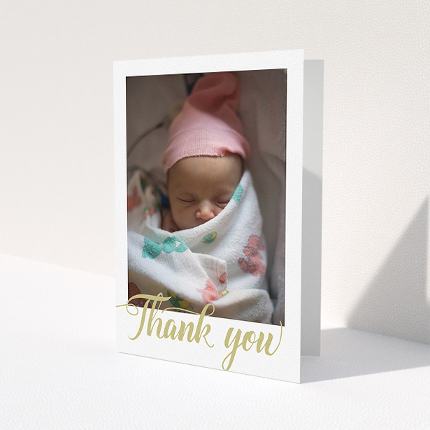 A baby thank you card design called "Golden Thank You". It is an A5 card in a portrait orientation. It is a photographic baby thank you card with room for 1 photo. "Golden Thank You" is available as a folded card, with tones of white and gold.