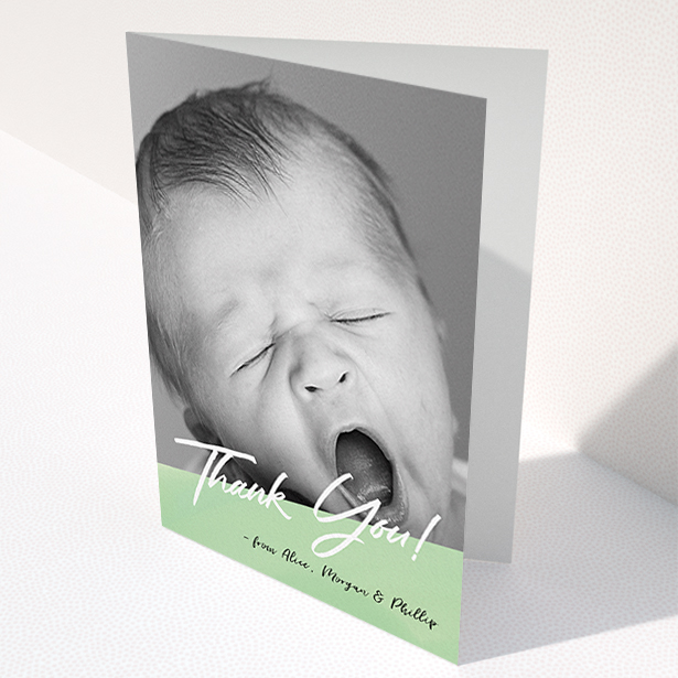 A baby thank you card design titled "Green Slant". It is an A6 card in a portrait orientation. It is a photographic baby thank you card with room for 1 photo. "Green Slant" is available as a folded card, with mainly green colouring.