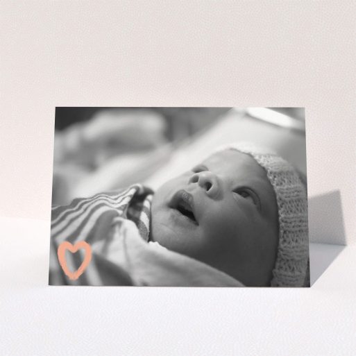 A baby thank you card design named "Hand Drawn Heart". It is an A5 card in a landscape orientation. It is a photographic baby thank you card with room for 1 photo. "Hand Drawn Heart" is available as a folded card, with mainly light pink colouring.