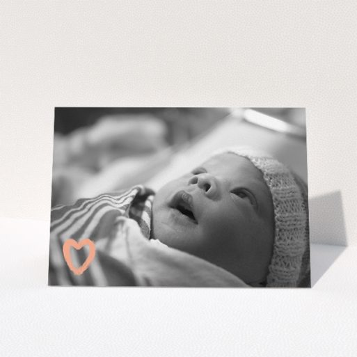 A baby thank you card design named "Hand Drawn Heart". It is an A5 card in a landscape orientation. It is a photographic baby thank you card with room for 1 photo. "Hand Drawn Heart" is available as a folded card, with mainly light pink colouring.
