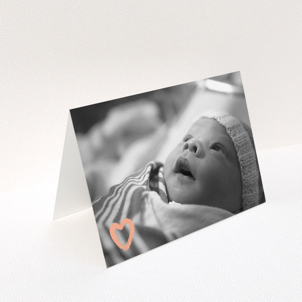 A baby thank you card design named "Hand Drawn Heart". It is an A5 card in a landscape orientation. It is a photographic baby thank you card with room for 1 photo. "Hand Drawn Heart" is available as a folded card, with mainly light pink colouring.