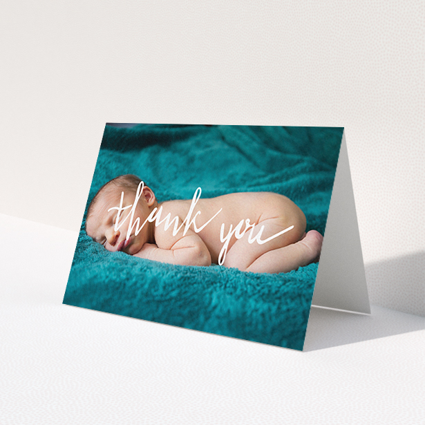 A baby thank you card design titled "Handwritten Thanks". It is an A6 card in a landscape orientation. It is a photographic baby thank you card with room for 1 photo. "Handwritten Thanks" is available as a folded card, with mainly white colouring.