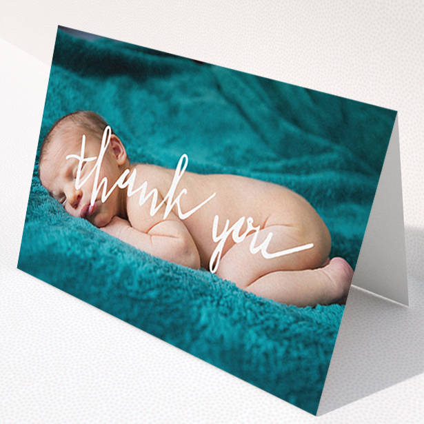 A baby thank you card design titled "Handwritten Thanks". It is an A6 card in a landscape orientation. It is a photographic baby thank you card with room for 1 photo. "Handwritten Thanks" is available as a folded card, with mainly white colouring.