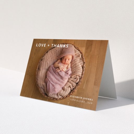 A baby thank you card named 'Love and Thanks Landscape'. It is an A5 card in a landscape orientation. It is a photographic baby thank you card with room for 1 photo. 'Love and Thanks Landscape' is available as a folded card, with mainly white colouring.