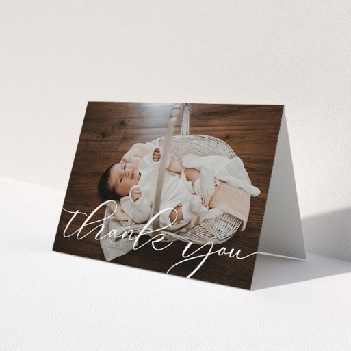A baby thank you card design called 'One Photo'. It is an A5 card in a landscape orientation. It is a photographic baby thank you card with room for 1 photo. 'One Photo' is available as a folded card, with mainly white colouring.