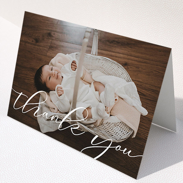 A baby thank you card design called "One Photo". It is an A5 card in a landscape orientation. It is a photographic baby thank you card with room for 1 photo. "One Photo" is available as a folded card, with mainly white colouring.