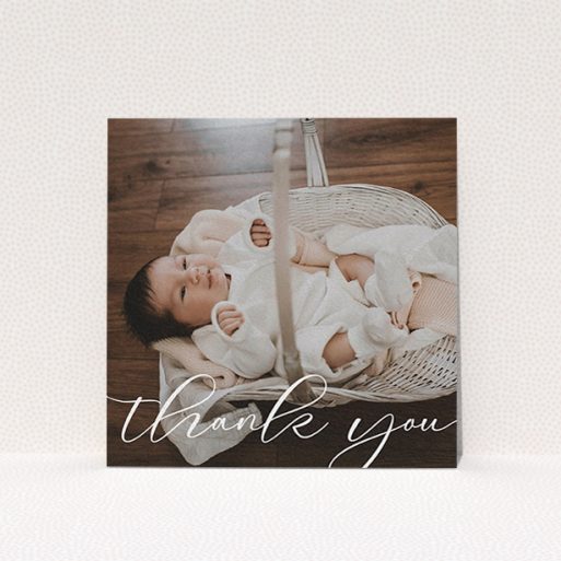 A baby thank you card template titled "One Photo". It is a square (148mm x 148mm) card in a square orientation. It is a photographic baby thank you card with room for 1 photo. "One Photo" is available as a flat card, with mainly white colouring.