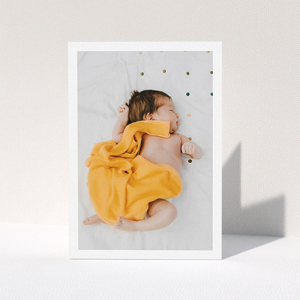 A baby thank you card template titled "One Photo Thanks". It is an A5 card in a portrait orientation. It is a photographic baby thank you card with room for 1 photo. "One Photo Thanks" is available as a folded card, with mainly white colouring.