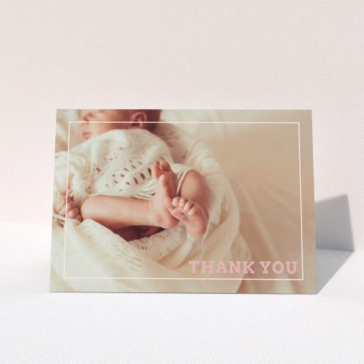 A baby thank you card design called "Over Photo Frame". It is an A6 card in a landscape orientation. It is a photographic baby thank you card with room for 1 photo. "Over Photo Frame" is available as a folded card, with mainly white colouring.