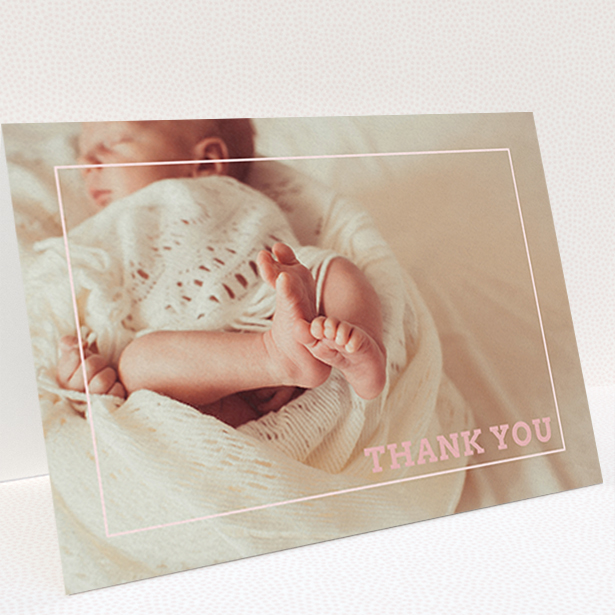 A baby thank you card design called "Over Photo Frame". It is an A6 card in a landscape orientation. It is a photographic baby thank you card with room for 1 photo. "Over Photo Frame" is available as a folded card, with mainly white colouring.