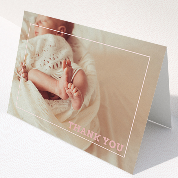 A baby thank you card design called "Over Photo Frame". It is an A6 card in a landscape orientation. It is a photographic baby thank you card with room for 1 photo. "Over Photo Frame" is available as a folded card, with mainly white colouring.