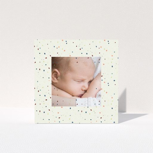 A baby thank you card design called "Pastel Dots". It is a square (148mm x 148mm) card in a square orientation. It is a photographic baby thank you card with room for 1 photo. "Pastel Dots" is available as a folded card, with tones of light cream and green.