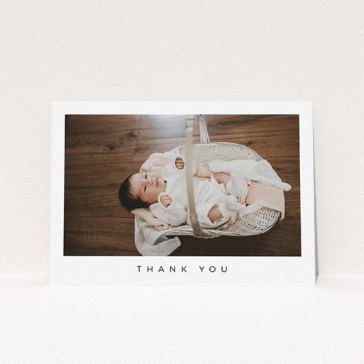 A baby thank you card design titled "Simple". It is an A5 card in a landscape orientation. It is a photographic baby thank you card with room for 1 photo. "Simple" is available as a flat card, with mainly white colouring.