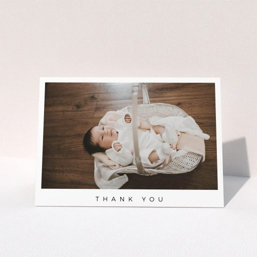 A baby thank you card design named "Simple". It is an A6 card in a landscape orientation. It is a photographic baby thank you card with room for 1 photo. "Simple" is available as a folded card, with mainly white colouring.