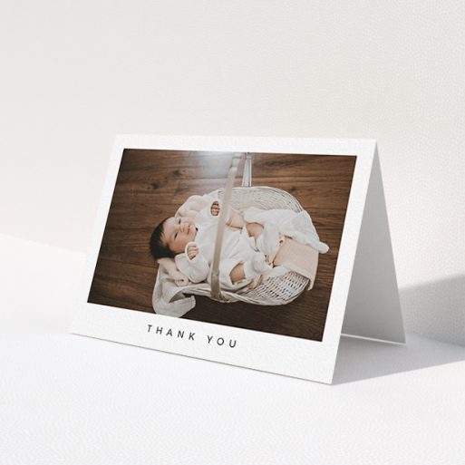 A baby thank you card design named 'Simple'. It is an A6 card in a landscape orientation. It is a photographic baby thank you card with room for 1 photo. 'Simple' is available as a folded card, with mainly white colouring.