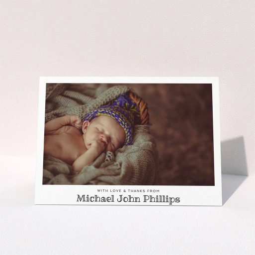 A baby thank you card named "Simple Photo Frame". It is an A5 card in a landscape orientation. It is a photographic baby thank you card with room for 1 photo. "Simple Photo Frame" is available as a folded card, with mainly white colouring.