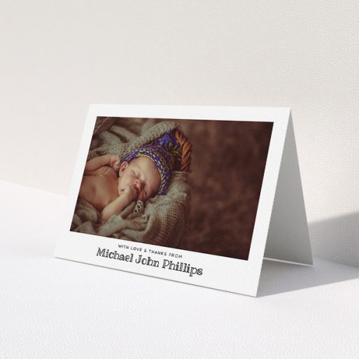 A baby thank you card named 'Simple Photo Frame'. It is an A5 card in a landscape orientation. It is a photographic baby thank you card with room for 1 photo. 'Simple Photo Frame' is available as a folded card, with mainly white colouring.