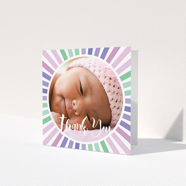 A baby thank you card design titled 'Sun Centre'. It is a square (148mm x 148mm) card in a square orientation. It is a photographic baby thank you card with room for 1 photo. 'Sun Centre' is available as a folded card, with mainly light pink colouring.