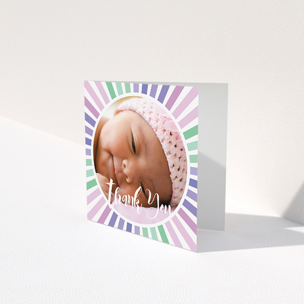 A baby thank you card design titled "Sun Centre". It is a square (148mm x 148mm) card in a square orientation. It is a photographic baby thank you card with room for 1 photo. "Sun Centre" is available as a folded card, with mainly light pink colouring.