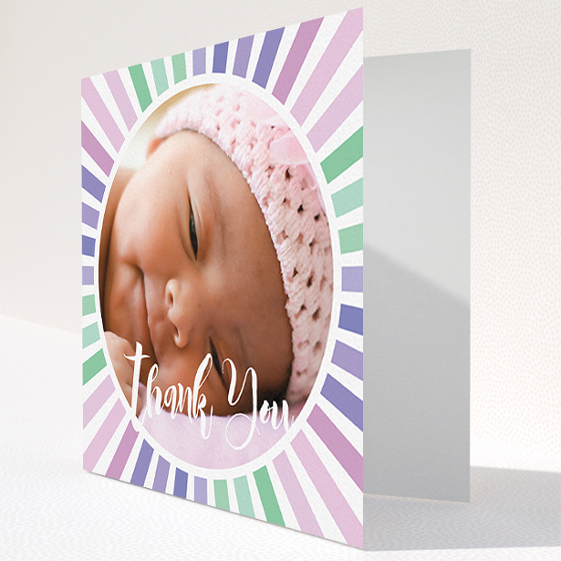 A baby thank you card design titled "Sun Centre". It is a square (148mm x 148mm) card in a square orientation. It is a photographic baby thank you card with room for 1 photo. "Sun Centre" is available as a folded card, with mainly light pink colouring.