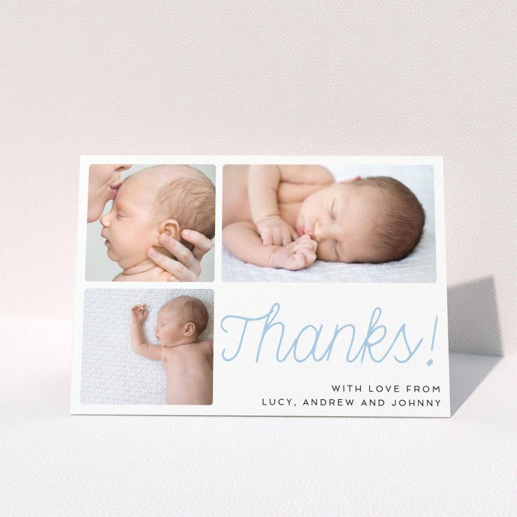 A baby thank you card called "Thank You Cursive". It is an A6 card in a landscape orientation. It is a photographic baby thank you card with room for 3 photos. "Thank You Cursive" is available as a folded card, with tones of white and blue.