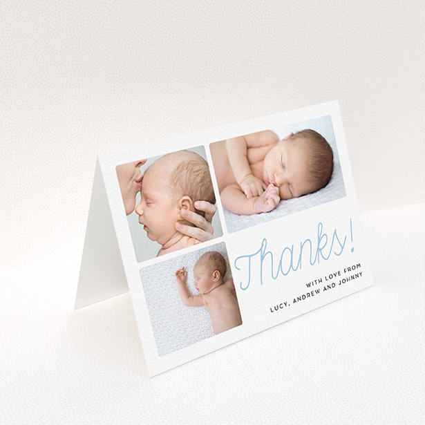 A baby thank you card called "Thank You Cursive". It is an A6 card in a landscape orientation. It is a photographic baby thank you card with room for 3 photos. "Thank You Cursive" is available as a folded card, with tones of white and blue.
