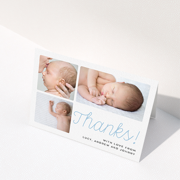 A baby thank you card called "Thank You Cursive". It is an A6 card in a landscape orientation. It is a photographic baby thank you card with room for 3 photos. "Thank You Cursive" is available as a folded card, with tones of white and blue.